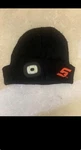 Black Knit Beanie Hat With Led Light & Red Logo For Winter Sports. Fixed Price $10.50.